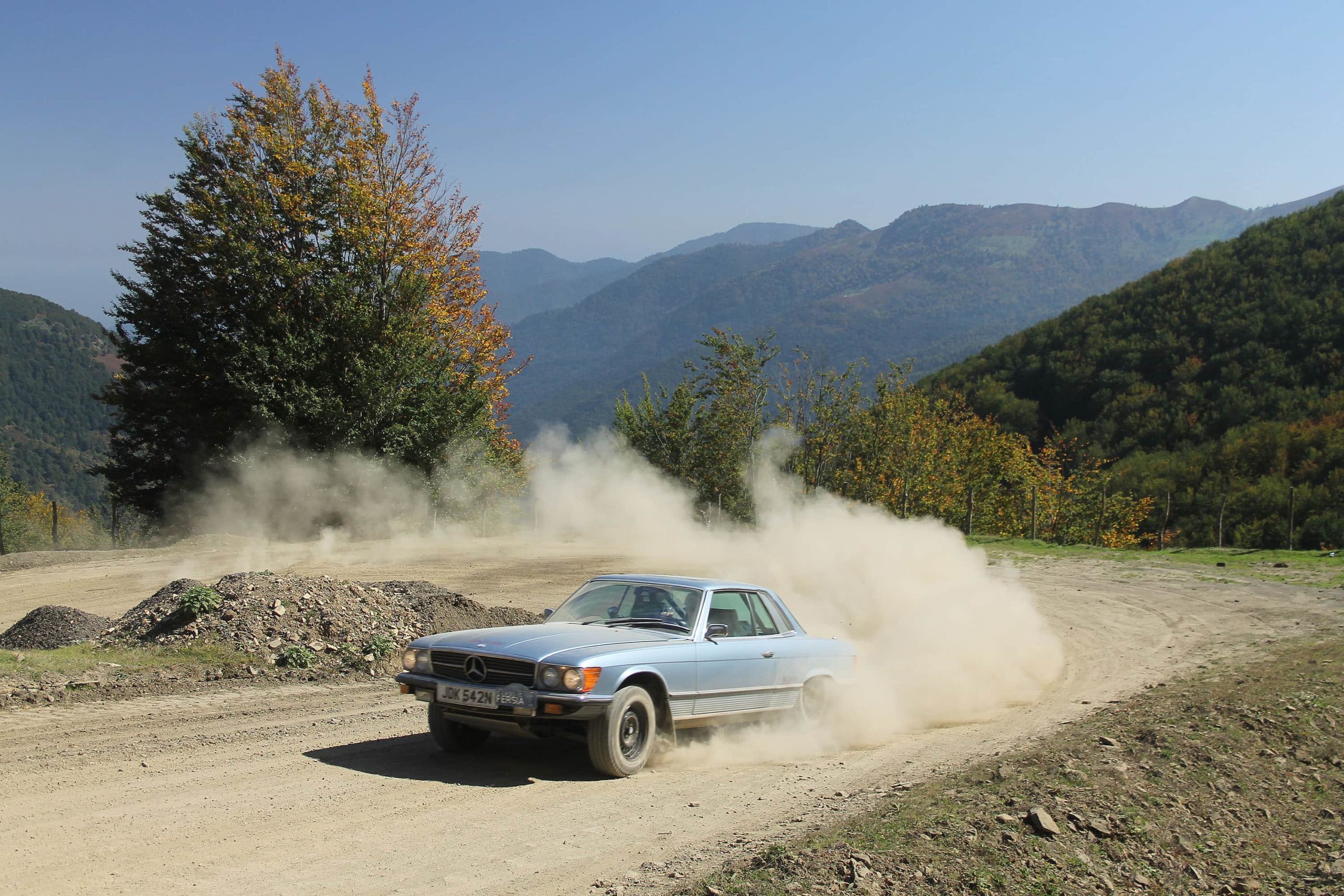 Rally SLC drifting around a dirt track.