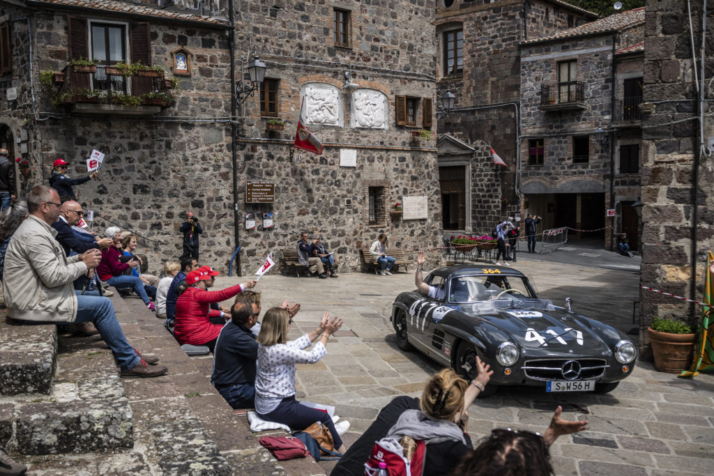Spectators wave at the Mercedes 300SL Gullwing