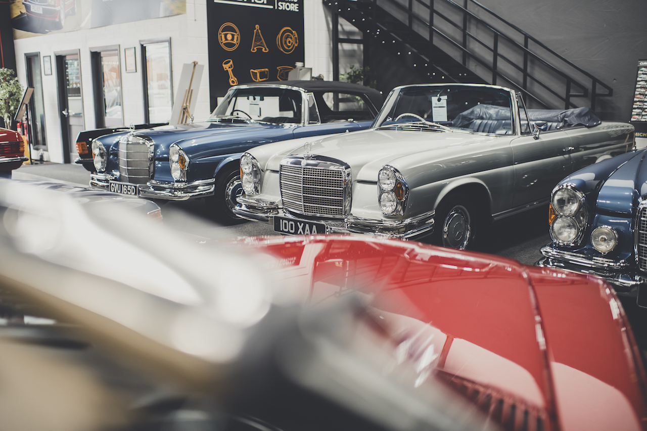 SLSHOP technician inspecting and welding a classic Mercedes