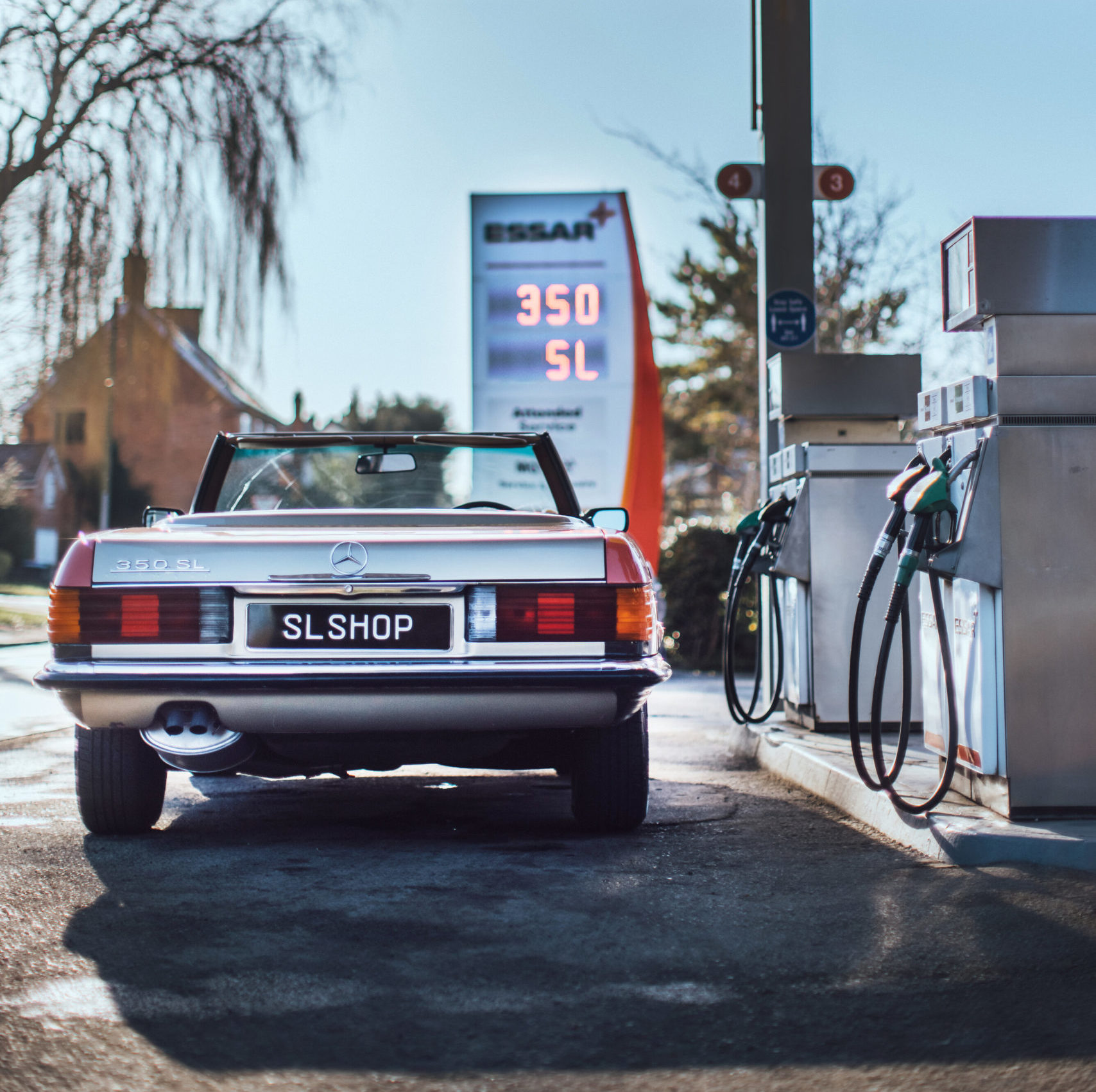 SLSHOP's 1971 Mercedes R107 350 SL standing proud a classic-style petrol station in the UK.