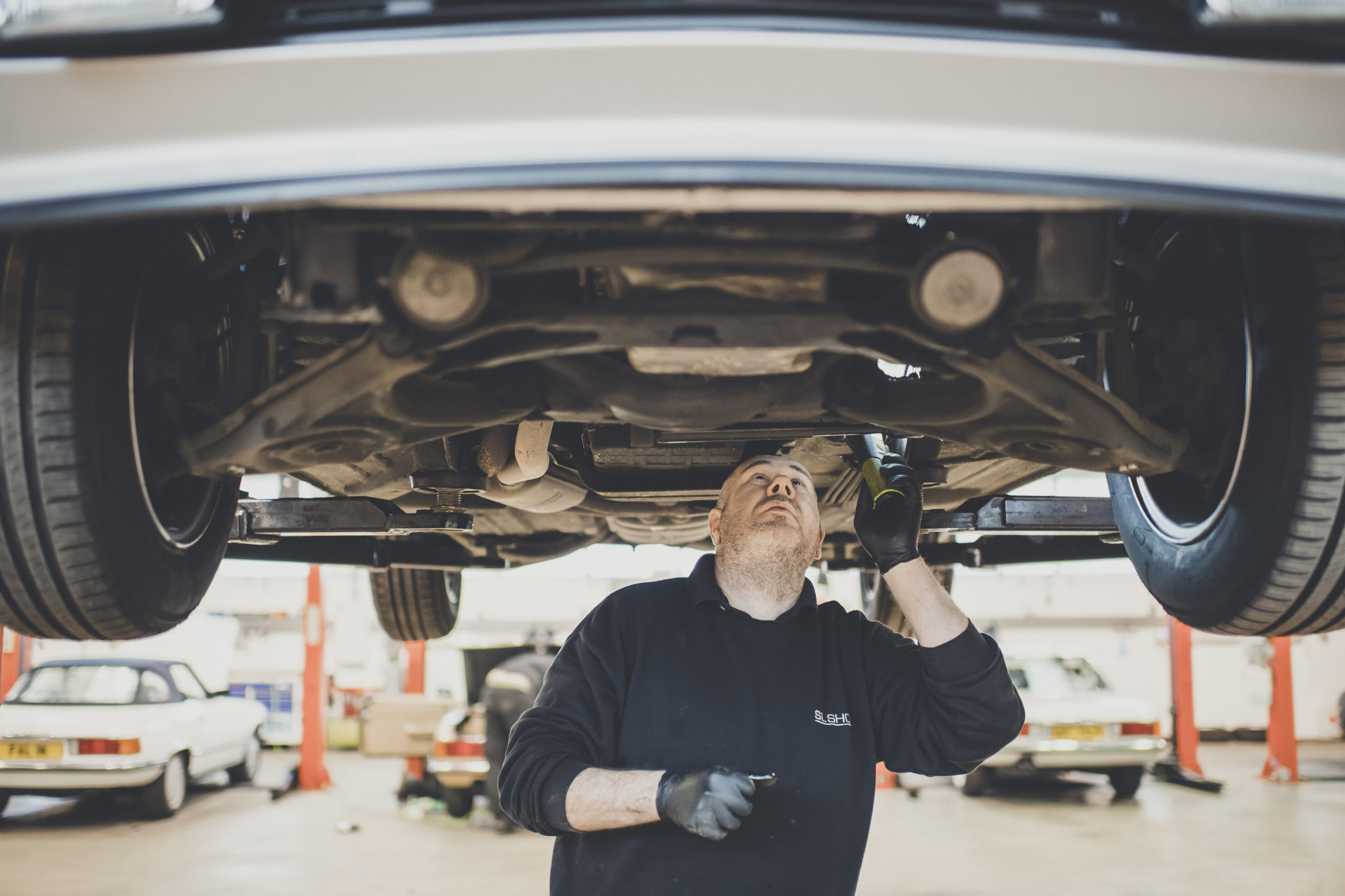 Man viewing undercarriage during R107 bulkhead repair 