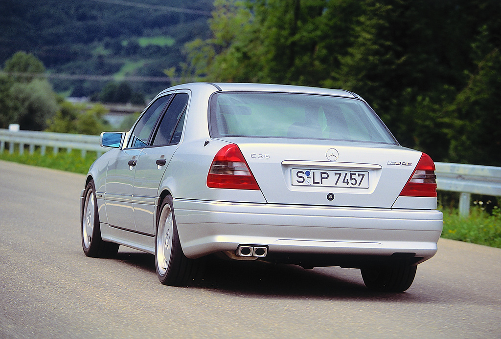 Mercedes SLK driving down a country road.