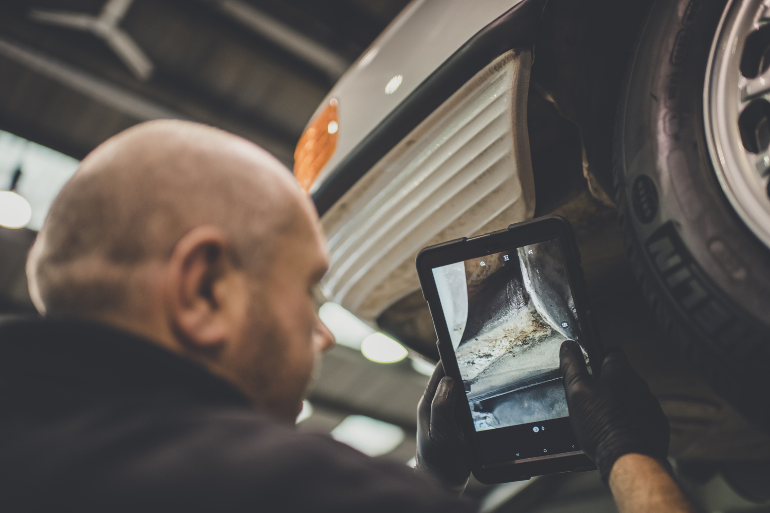 Man viewing undercarriage during R107 bulkhead repair 