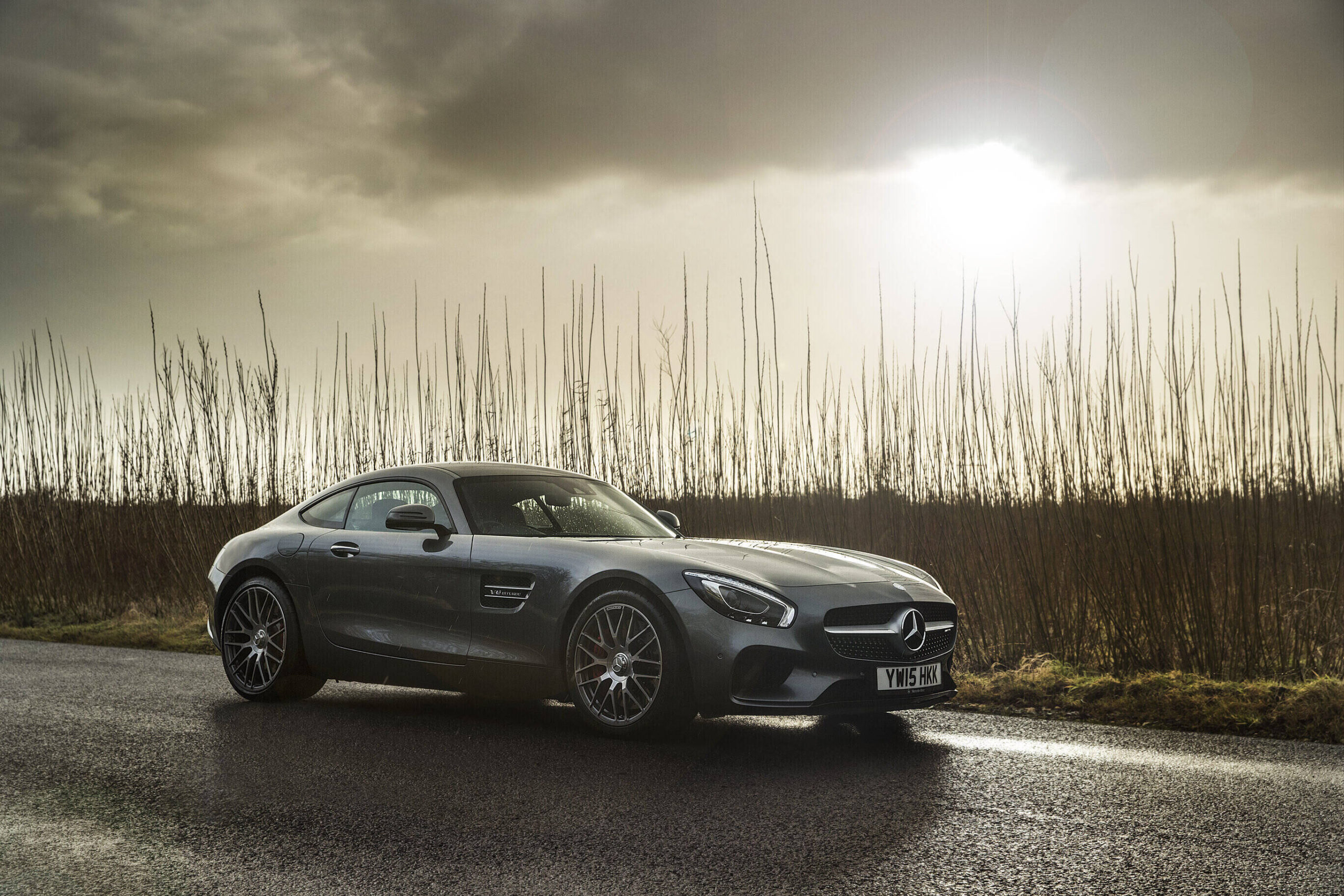 Mercedes AMG GTS on wet spring road.
