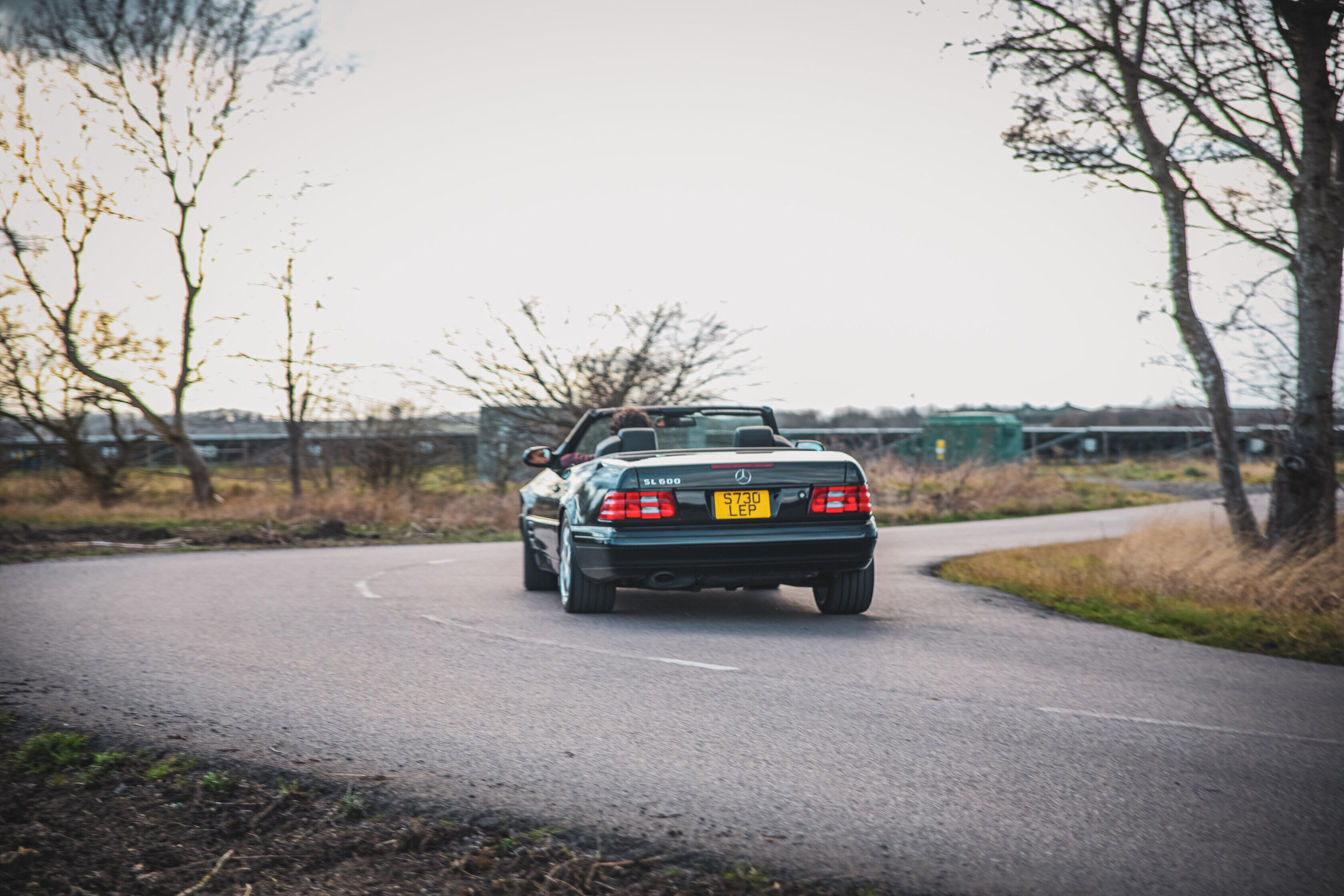 Mercedes R129 SL turning a corner.