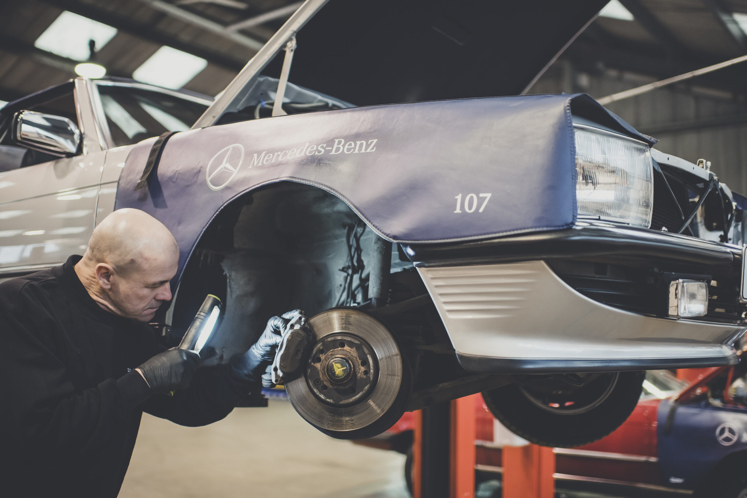 Man viewing undercarriage during R107 bulkhead repair 