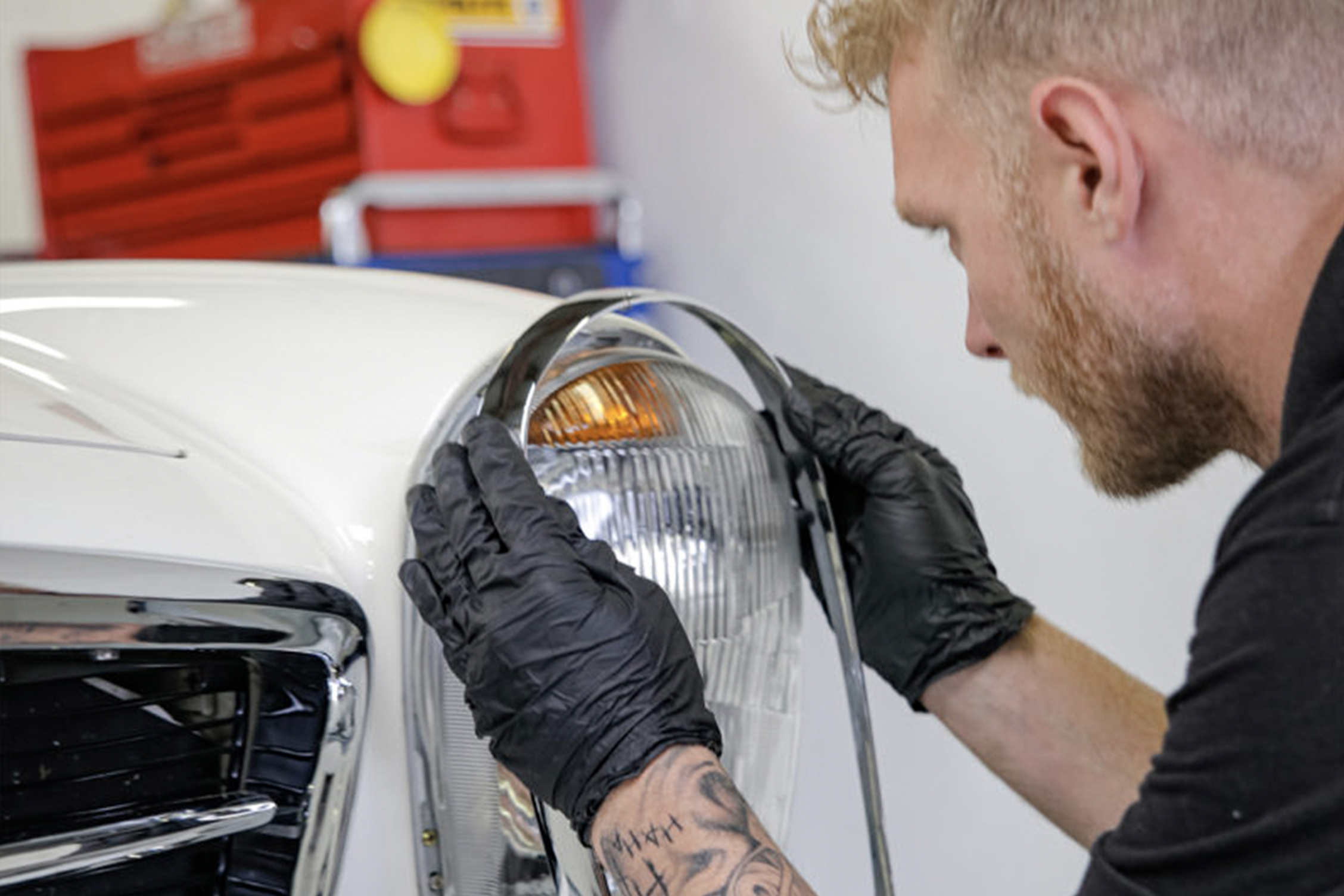 W113 Pagoda headlamp chrome being fitted.